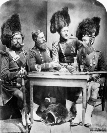 CRIMEAN WAR 1854 - 1856 (Q 71646) Portrait of Piper David Muir, George Glen, Donald McKenzie and Colour Sergeant William Gardner, 42nd Royal Highlanders, posed grouped round a table with drinks at Aldershot. Copyright: © IWM. Original Source: http://www.iwm.org.uk/collections/item/object/205018832